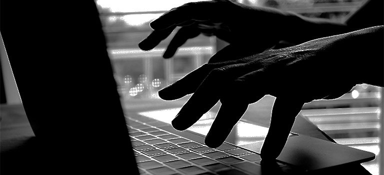 Cybersecurity attacks, black and white, criminal typing on keyboard, cyber attack