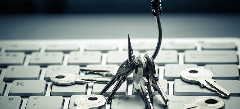 Keys on fishing hook over keyboard, concept social phishing