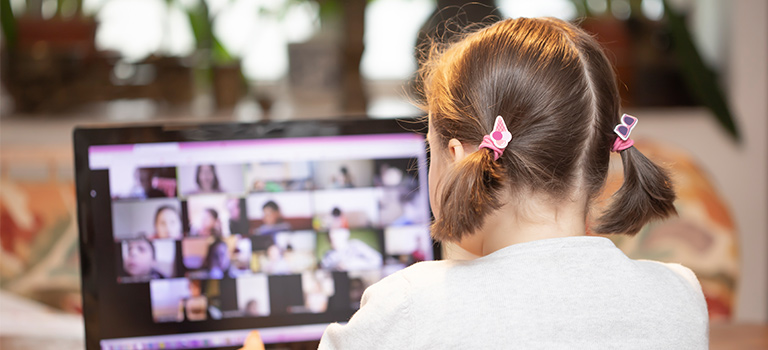 Girl at computer distance learning online skype teaching class